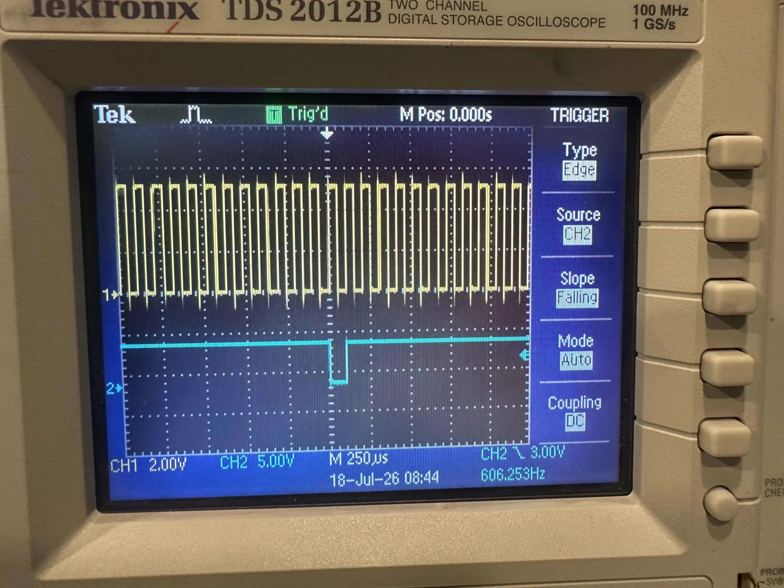 Tektronix TDS 2012B oscilloscope displaying the MASTR III DSP clock and data waveforms during bench testing